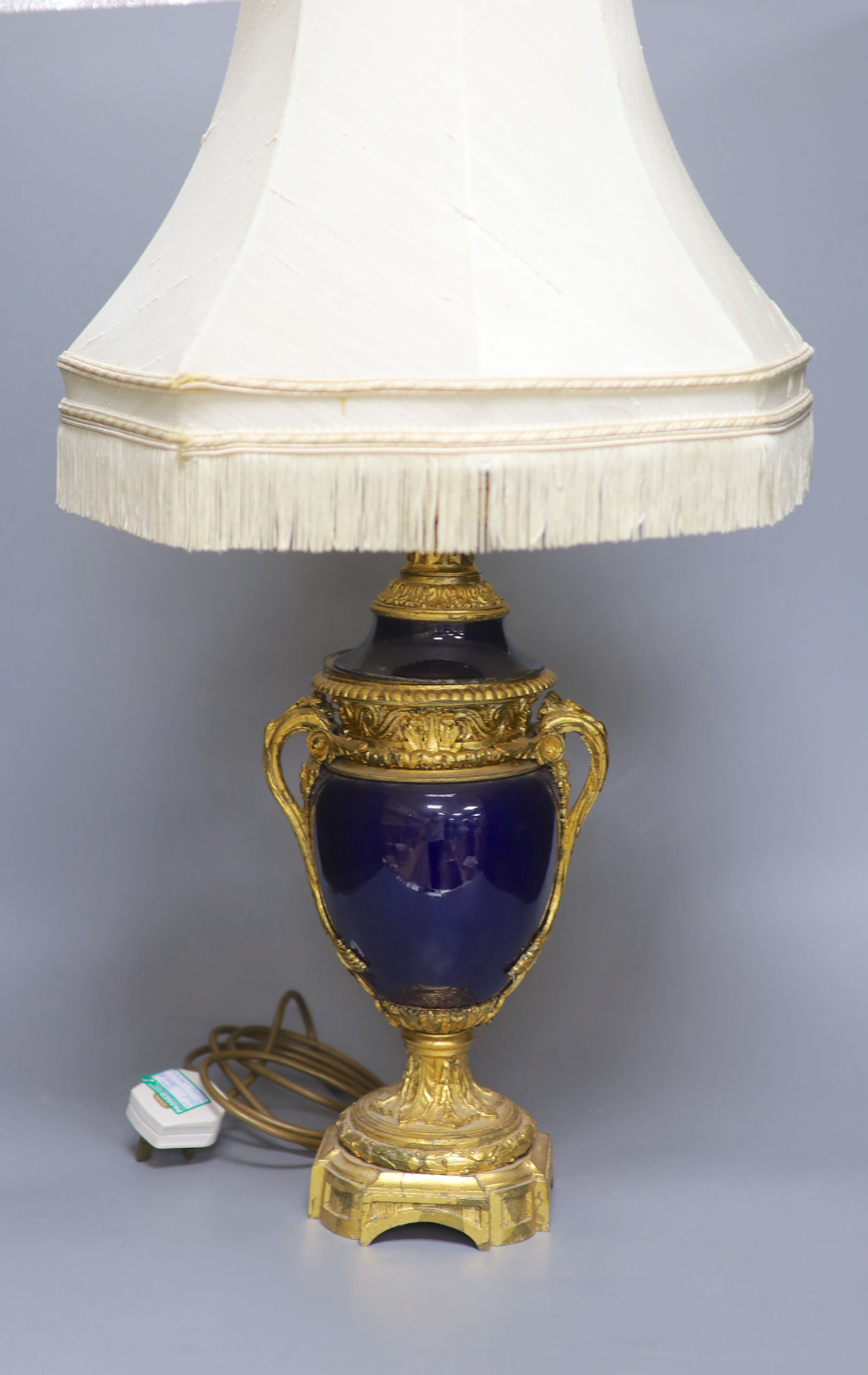 A French gilt metal and porcelain table lamp